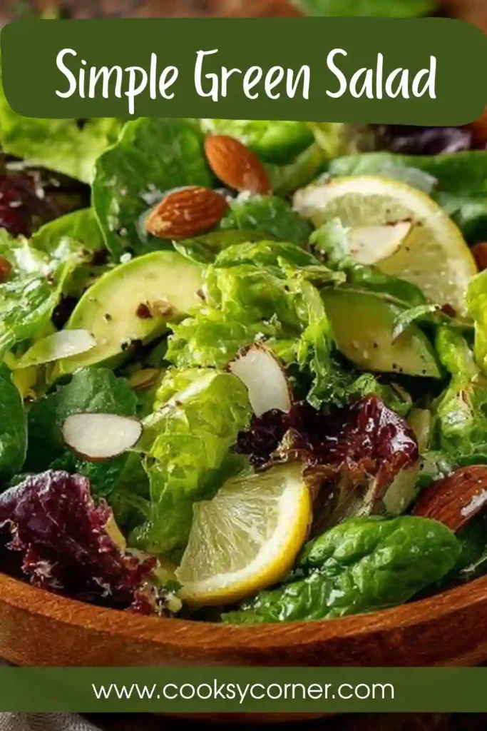 A Simple Green Salad made with butter lettuce, avocado slices, cucumber, Parmesan cheese, pepitas, and microgreens. The salad is tossed with lemon vinaigrette and topped with roasted tamari almonds.