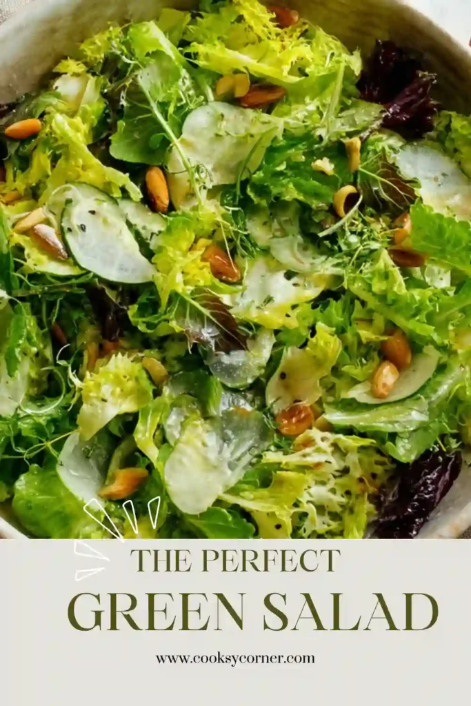 Fresh green salad featuring crisp lettuce, creamy avocado, sliced cucumber, shaved Parmesan, and crunchy roasted almonds. A healthy and colorful side dish with lemon dressing.