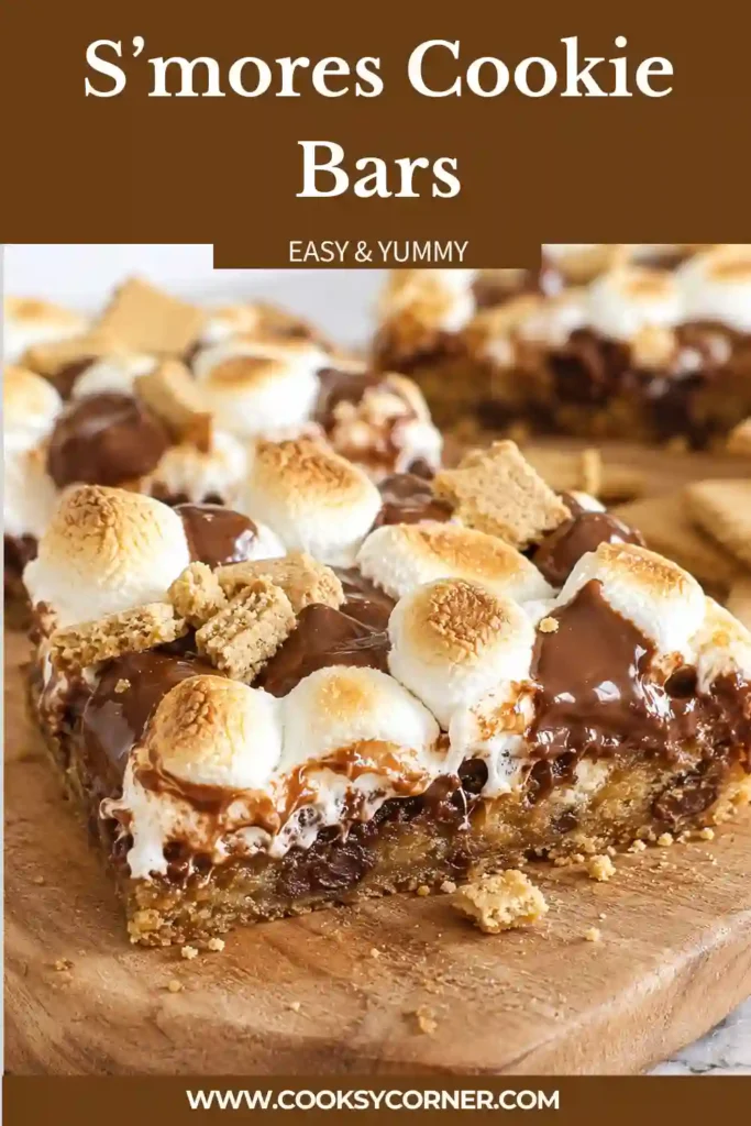 Homemade S’mores Cookie Bars arranged on parchment paper with melted chocolate visible.