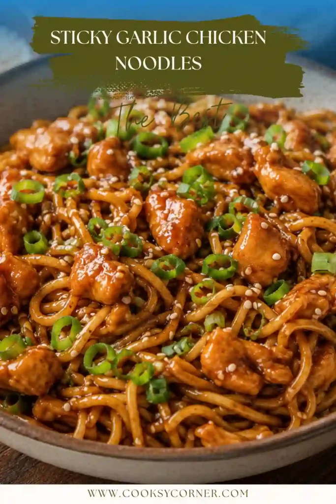 Close-up view of Sticky Garlic Chicken Noodles in a serving bowl with tender chicken and garlic sauce. Garnished with green onions and sesame seeds.