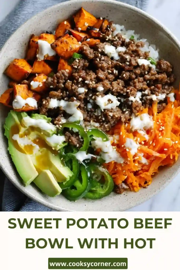 A colorful Sweet Potato Beef Bowl with Hot Honey featuring roasted sweet potatoes, seasoned ground beef, black beans, avocado, cottage cheese, and cheddar cheese. This healthy high-protein bowl is topped with a sweet and spicy hot honey drizzle.
