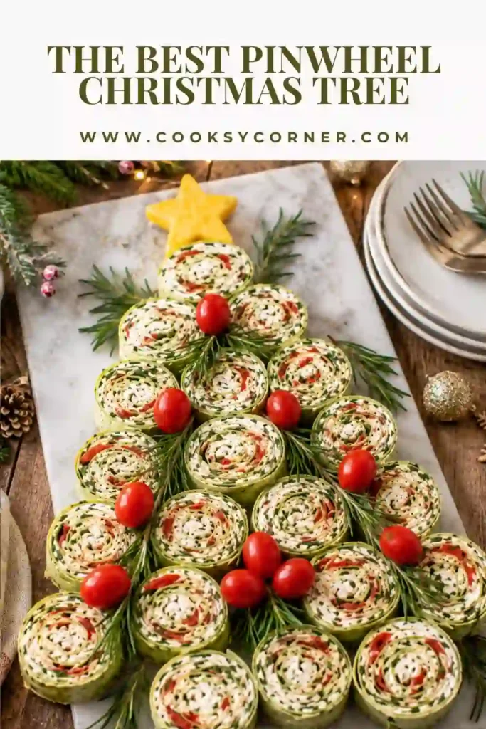 Christmas pinwheel wraps shaped like a holiday tree and garnished with fresh rosemary and tomatoes. A creative and easy Christmas party appetizer for family gatherings.
