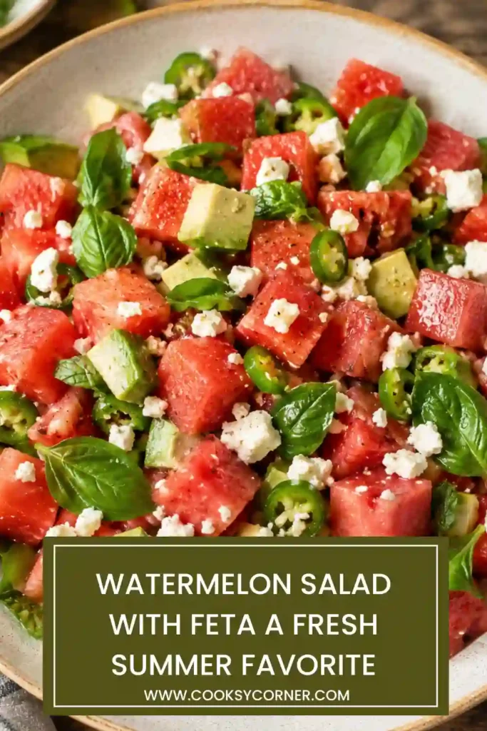 A fresh Watermelon Salad with Feta served on a platter with cucumber, avocado, red onion, and mint leaves. The colorful ingredients are drizzled with a light lime dressing.