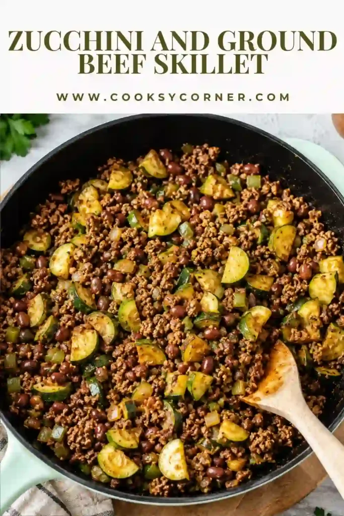 A skillet filled with zucchini, ground beef, mushrooms, tomatoes, black olives, and melted cheddar cheese. This easy one-pan dinner is hearty, colorful, and packed with flavor.