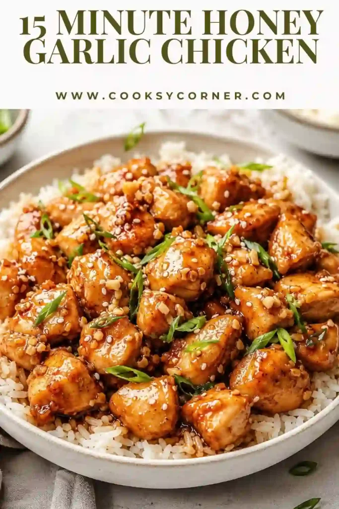 Tender Honey Garlic Chicken garnished with sesame seeds and sliced green onions alongside fluffy rice. A delicious one-pan chicken recipe for busy evenings.