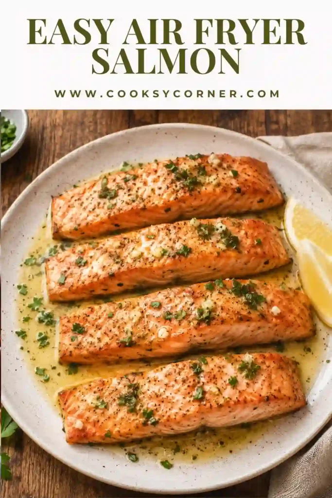 Close-up of flaky Air Fryer Salmon finished with melted garlic butter and fresh herbs. A quick high-protein meal that's perfect for weeknight dinners.