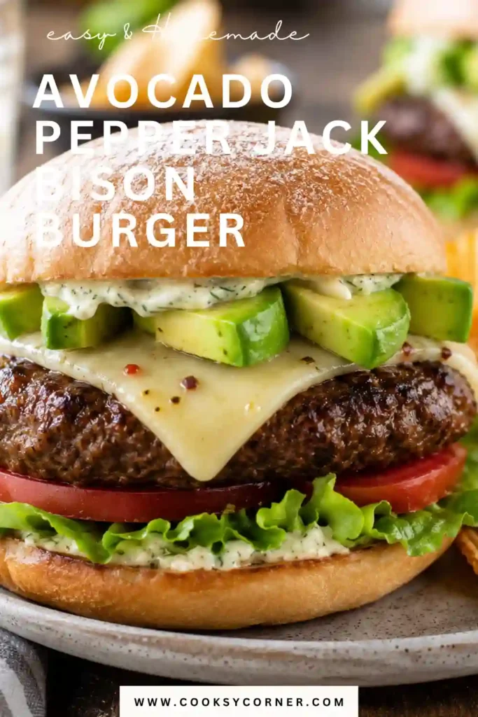 A juicy Avocado Pepper Jack Bison Burger topped with melted Pepper Jack cheese, creamy avocado slices, lettuce, and tomato on a soft bakery bun. This grilled bison burger is fresh, hearty, and perfect for summer meals.