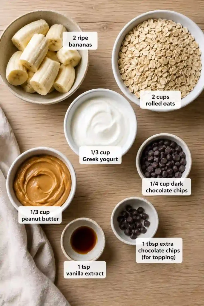 Healthy Banana Oatmeal Bars with Greek Yogurt cooling after baking in a parchment-lined pan. These baked oatmeal bars are perfect for meal prep and family-friendly snacking.