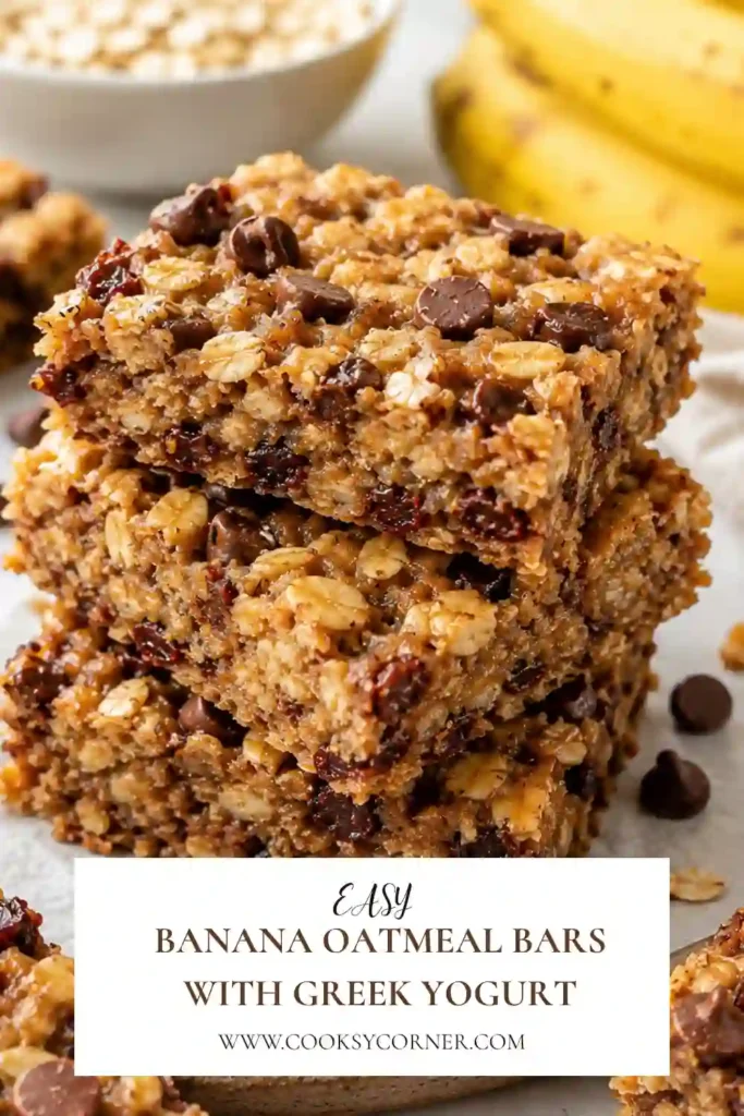 Freshly baked Banana Oatmeal Bars with Greek Yogurt are sliced into squares, revealing a soft, chewy texture with melted dark chocolate chips. These healthy banana oatmeal bars are naturally sweetened with ripe bananas.