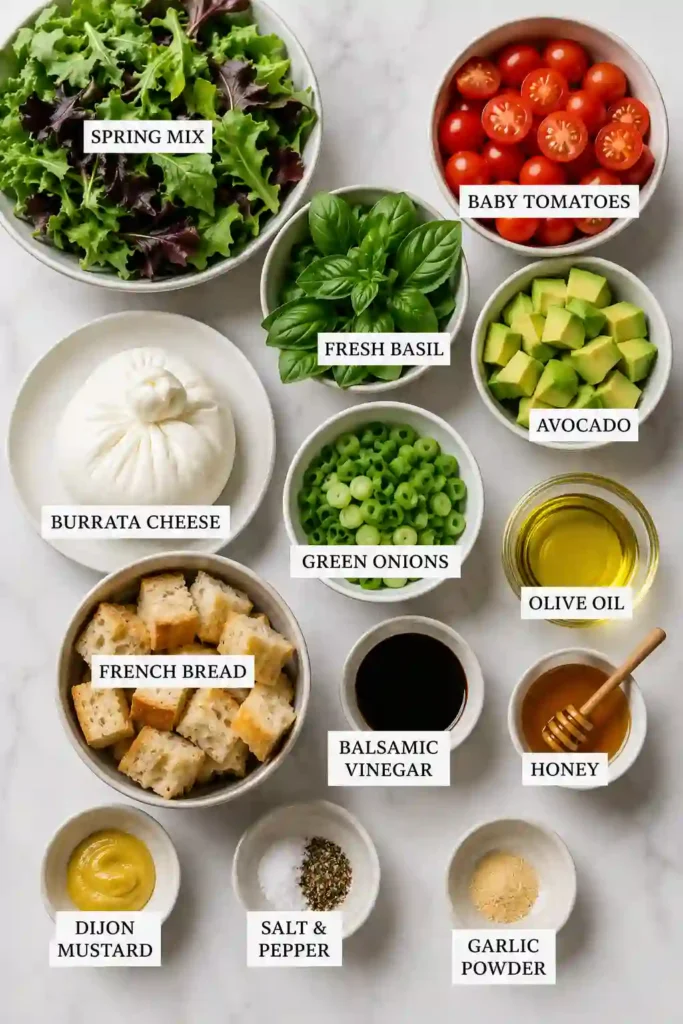 Fresh Burrata Salad Recipe served on a large platter with vibrant vegetables, homemade croutons, basil, and a sweet balsamic vinaigrette.