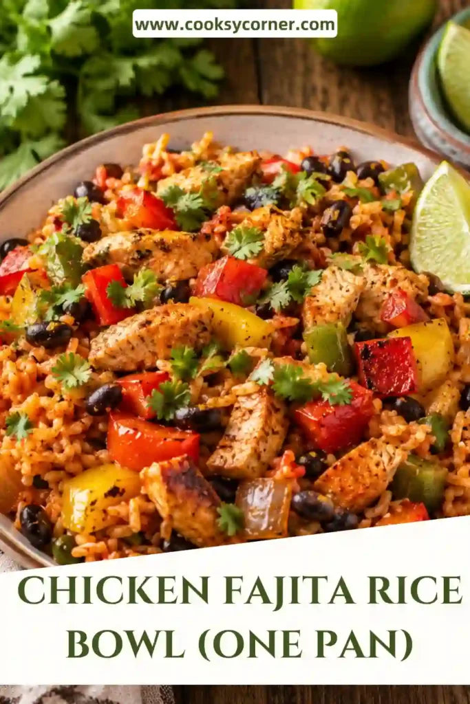 A vibrant Chicken Fajita Rice Bowl featuring seasoned chicken, colorful bell peppers, black beans, tomatoes, fluffy brown rice, melted cheese, and fresh cilantro served in a skillet.