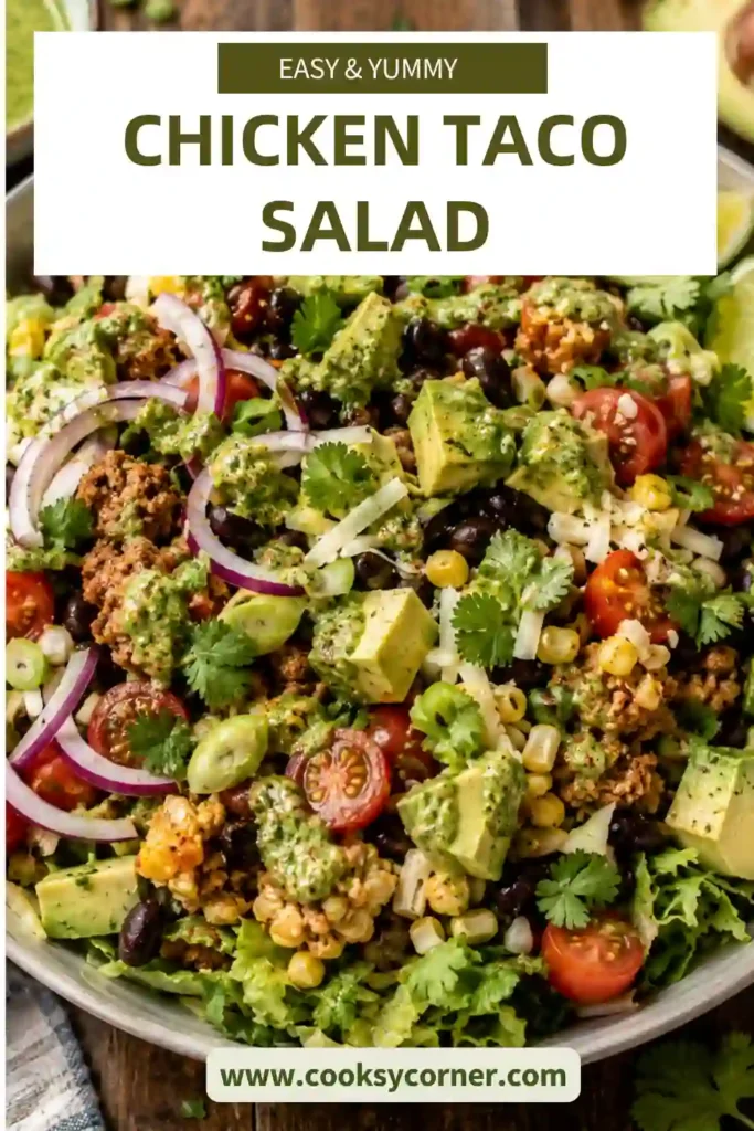 Fresh ingredients for Chicken Taco Salad arranged on a marble countertop, including ground chicken, romaine lettuce, tomatoes, avocado, corn, black beans, cheddar cheese, cilantro, onion, garlic, and dressing ingredients.