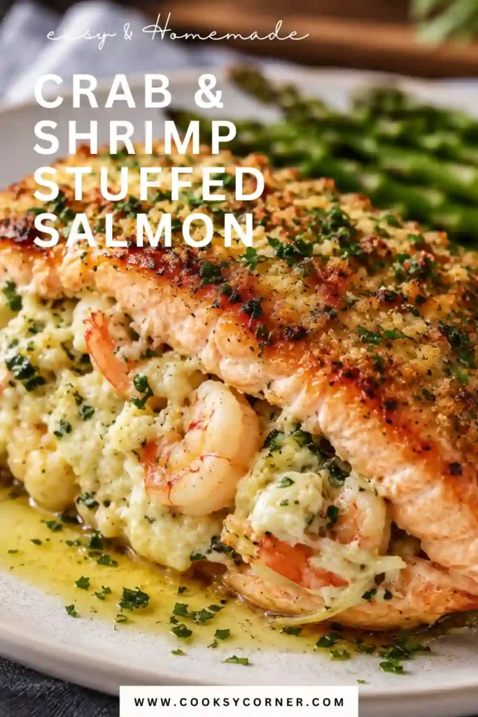 A golden-brown Crab & Shrimp Stuffed Salmon served on a white plate with fresh parsley and lemon wedges. The flaky salmon is filled with a creamy seafood stuffing made from crab, shrimp, and cream cheese.