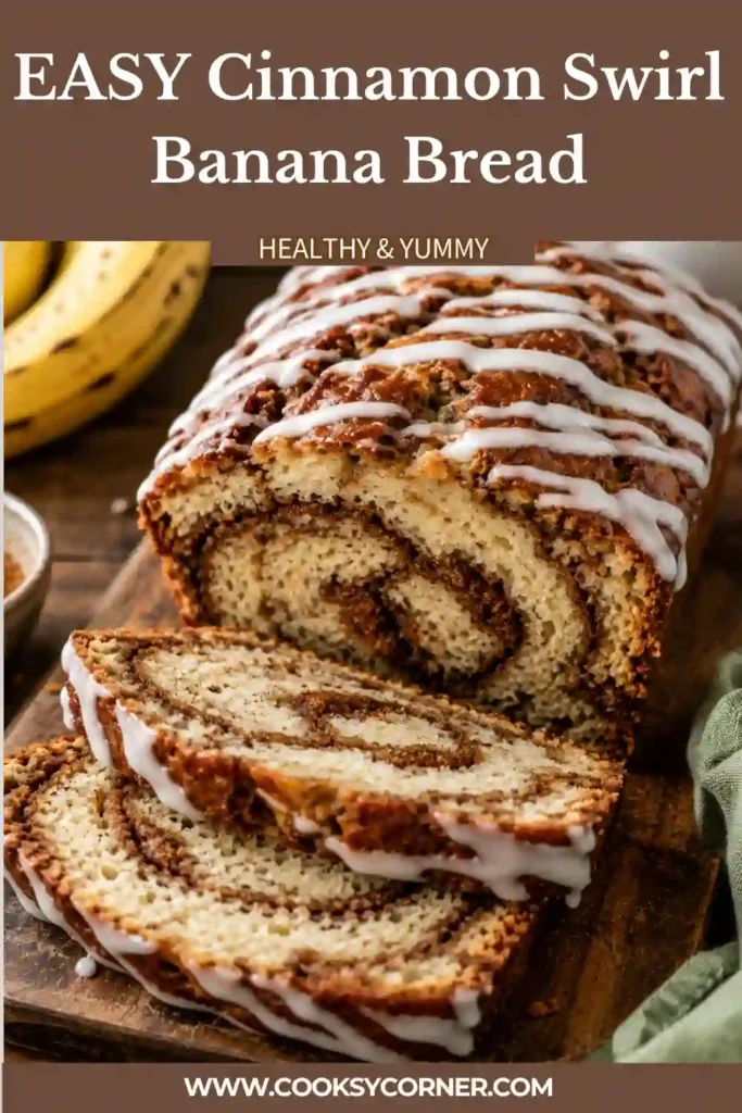 Golden brown Cinnamon Swirl Banana Bread cooling on a wire rack with thick vanilla icing drizzled over the top.