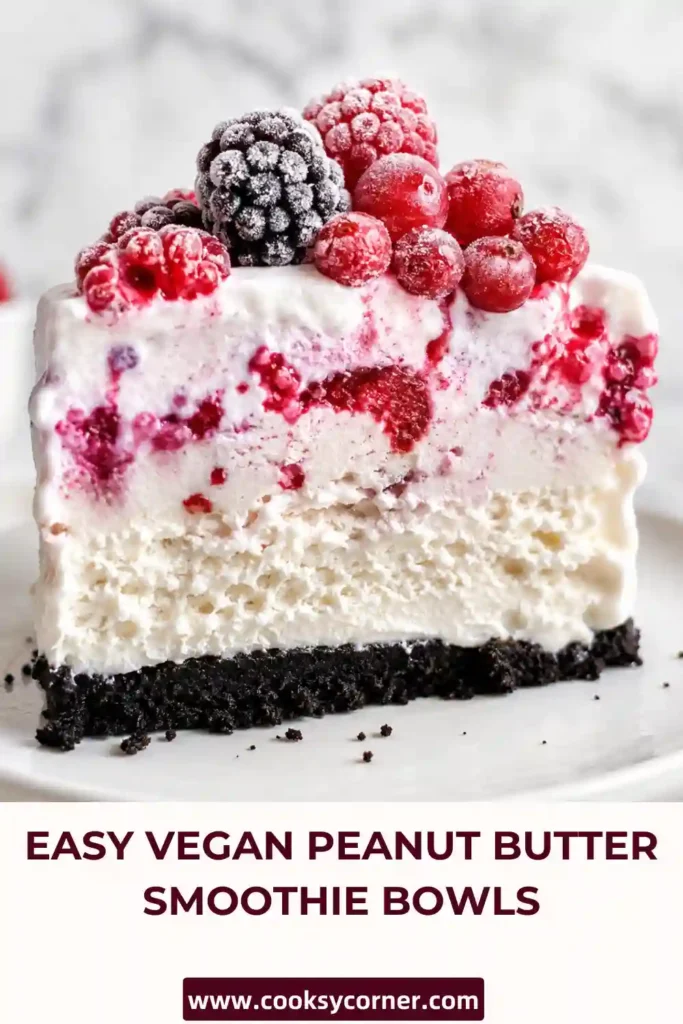 Thick slices of Easy Berry Ice Cream Cake topped with frozen mixed berries and fresh mint. The layered frozen dessert looks vibrant and perfect for entertaining.