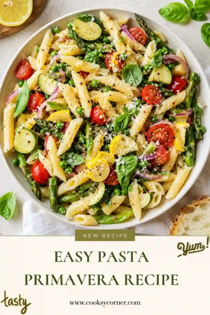 A bowl of Easy Pasta Primavera made with penne, asparagus, zucchini, squash, cherry tomatoes, peas, and fresh basil. The colorful vegetable pasta is finished with grated Pecorino cheese and fresh lemon.