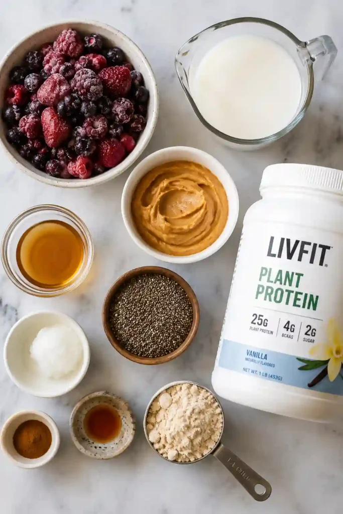 Colorful berry smoothie bowl featuring creamy peanut butter, vegan protein, and wholesome toppings. A delicious plant-based breakfast option.