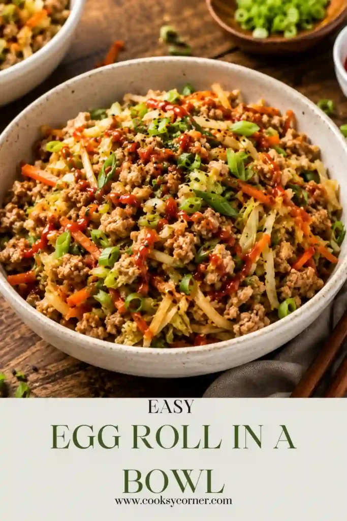 A healthy egg roll bowl topped with sliced avocado, sesame seeds, cilantro, and green onions. This easy dinner is rich in protein and vegetables.
