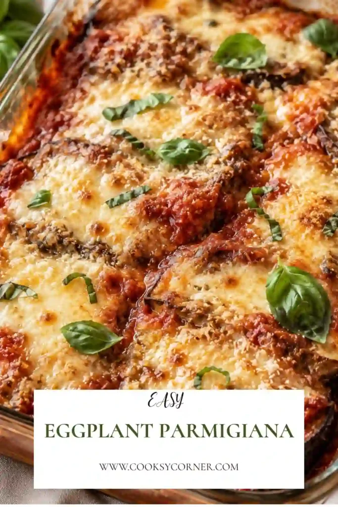 Freshly baked Eggplant Parmigiana layered with roasted eggplant, rich tomato sauce, melted mozzarella, and Parmesan cheese. Garnished with fresh basil for an authentic Italian presentation.