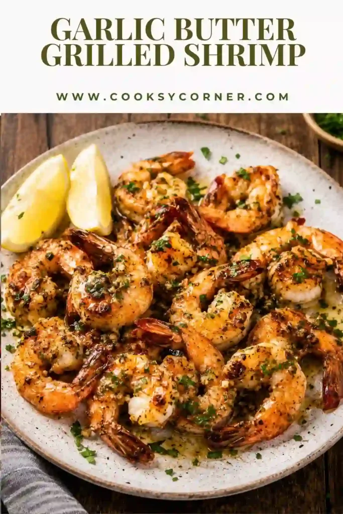 Homemade Garlic Butter Grilled Shrimp served with grilled vegetables and fresh parsley on a summer barbecue platter.