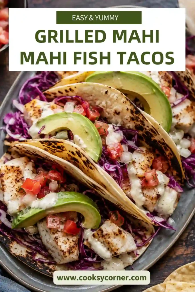 Grilled Mahi Mahi Fish Tacos served on warm corn tortillas with cabbage slaw, avocado slices, pico de gallo, and avocado tomatillo salsa. A colorful and healthy seafood dinner.