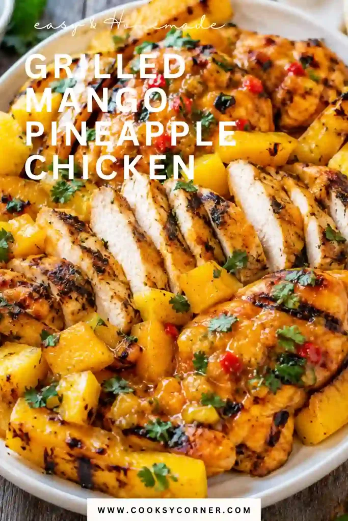 1. Grilled Mango Pineapple Chicken served with charred yellow bell peppers, fresh mango, pineapple, and cilantro on a serving platter. This tropical grilled chicken recipe is colorful, juicy, and perfect for summer meals.