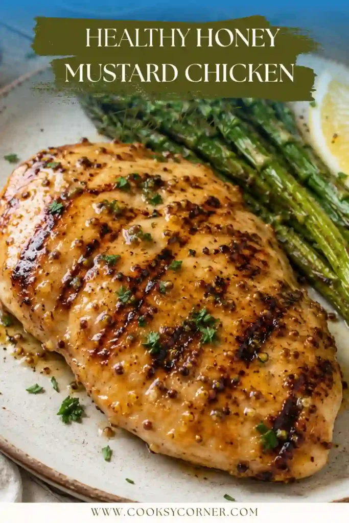 Close-up of Honey Mustard Chicken featuring caramelized grilled chicken breasts coated in a glossy honey mustard glaze and served with fresh herbs.