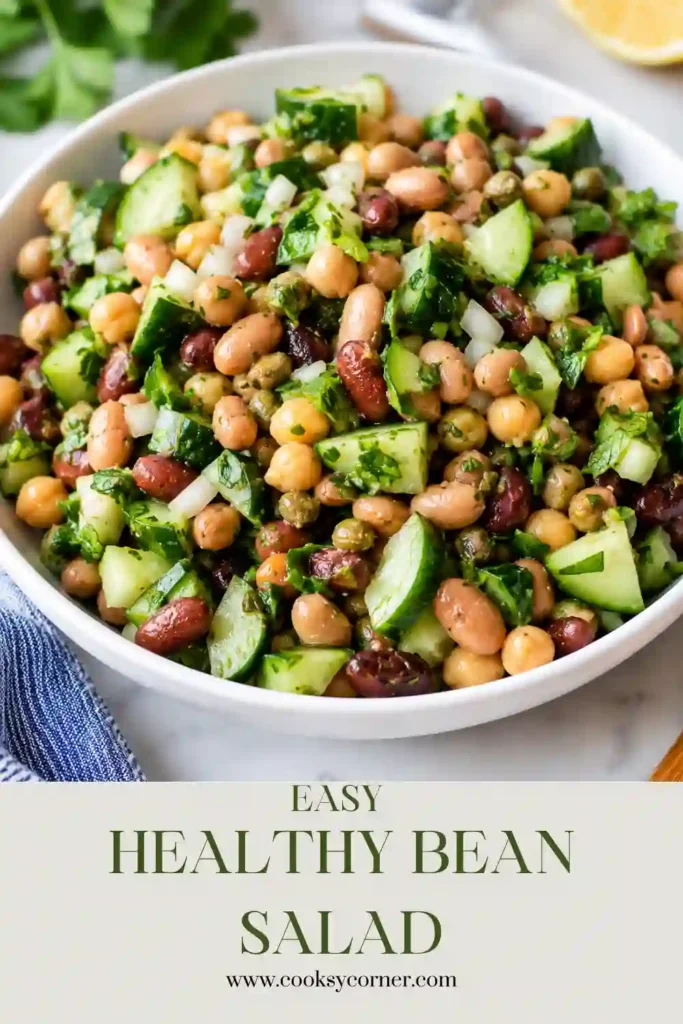 A bowl of Easy Bean Salad made with mixed beans, cucumber, parsley, capers, and a tangy vinaigrette. This healthy bean salad is colorful, refreshing, and perfect for meal prep.