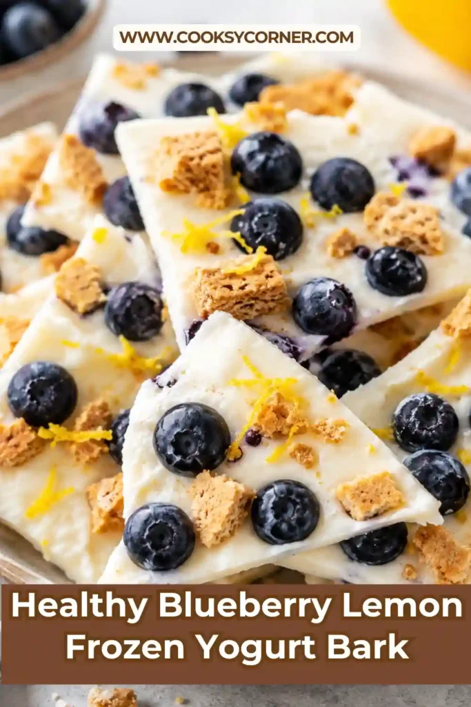 Healthy blueberry yogurt bark arranged on parchment paper with fresh blueberries and lemon zest. An easy no-bake frozen dessert for warm weather.