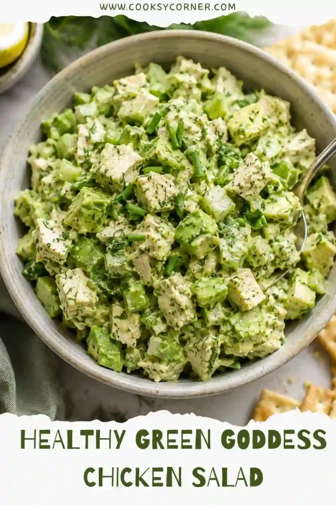 Homemade Green Goddess Chicken Salad garnished with parsley, dill, and chives, served with crackers. A quick and easy high-protein salad recipe.