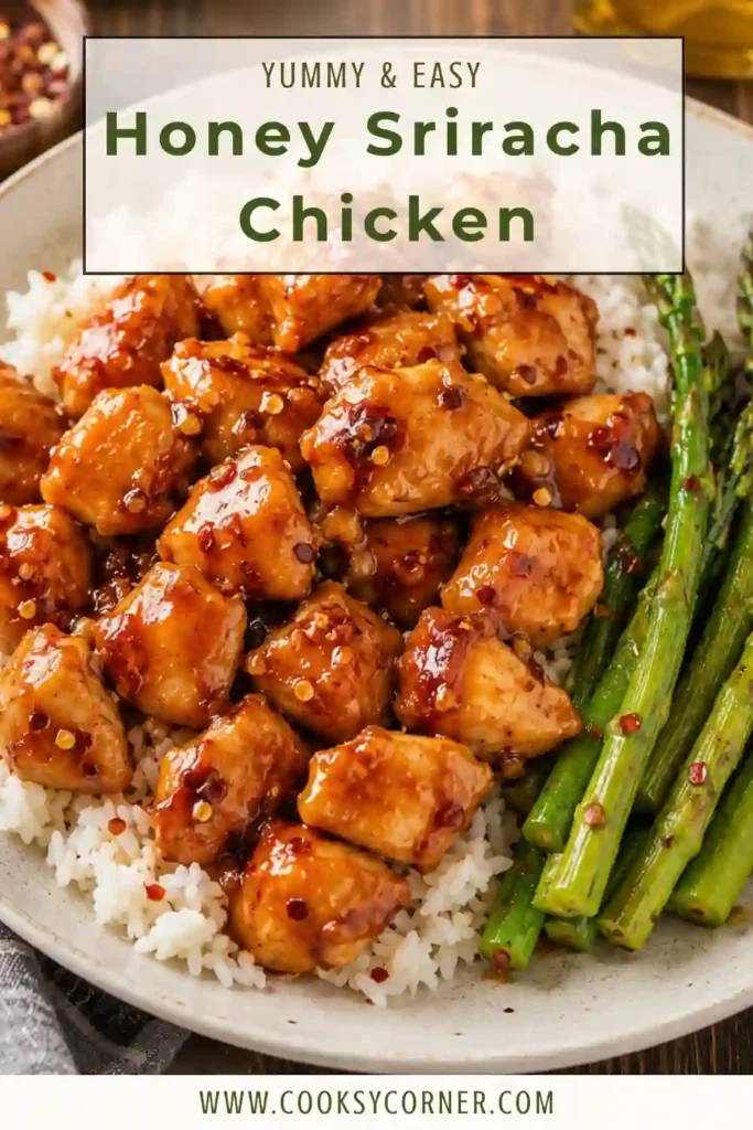 A bowl of Honey Sriracha Chicken served over steamed jasmine rice and garnished with sesame seeds, chopped green onions, and red pepper flakes.