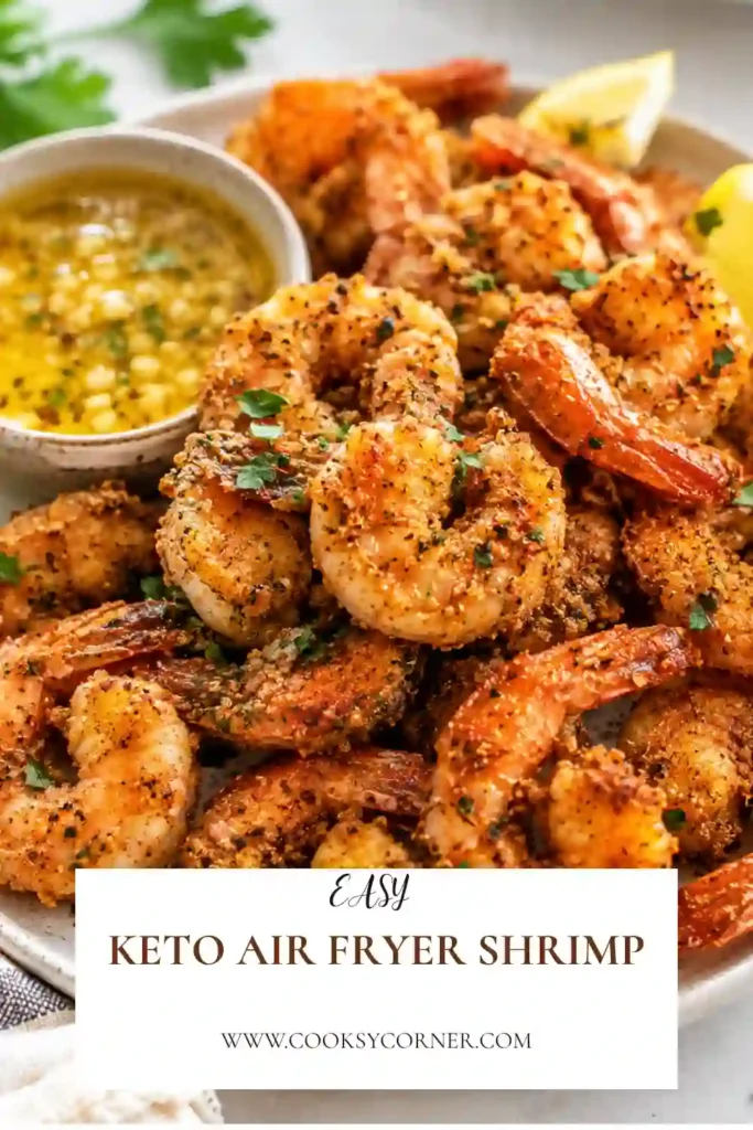 Freshly cooked low-carb air fryer shrimp with crispy almond flour breading arranged on a serving platter with dipping sauce.