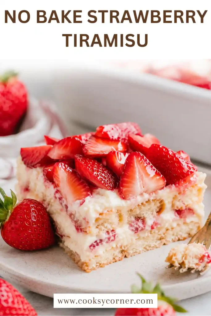 A No-Bake Strawberry Tiramisu layered with strawberry-soaked ladyfingers, mascarpone cream, and fresh sliced strawberries in a glass baking dish. The dessert is chilled and beautifully garnished.