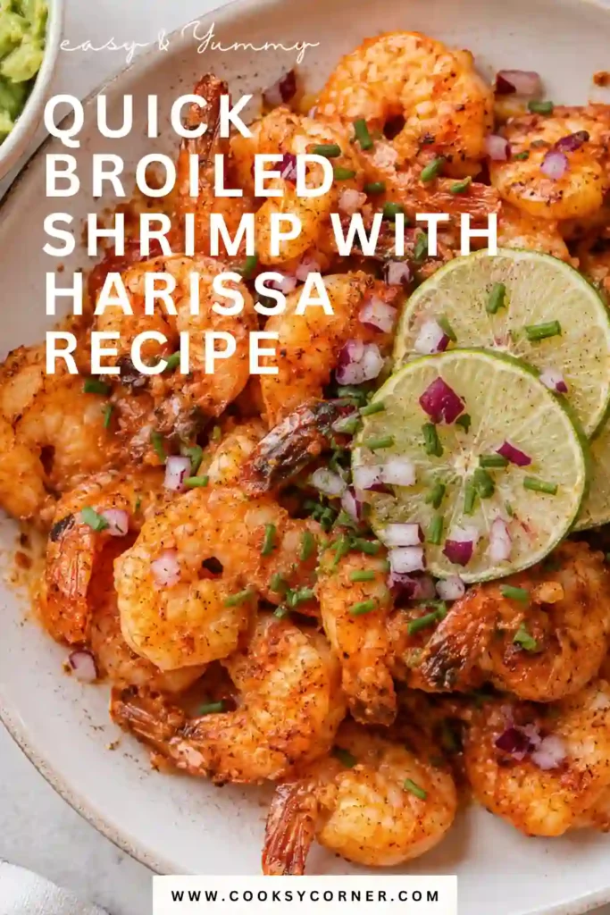 A skillet filled with spicy harissa shrimp finished with fresh herbs and lemon. The vibrant butter sauce coats every shrimp beautifully.