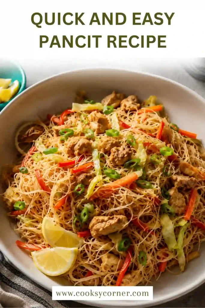 A close-up of stir-fried rice noodles with chicken, cabbage, carrots, and garlic. The Quick and Easy Pancit Recipe is fresh, flavorful, and family friendly.