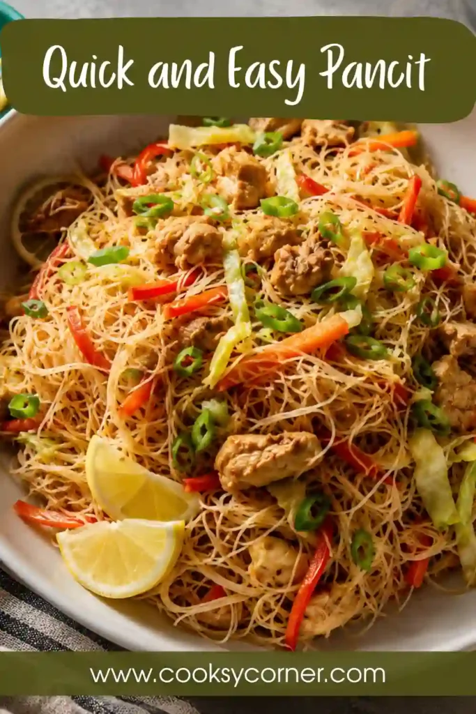 A serving of Quick and Easy Pancit Recipe featuring rice noodles, chicken, cabbage, and carrots tossed in savory soy sauce. Fresh lemon wedges add bright flavor to this Filipino noodle dish.