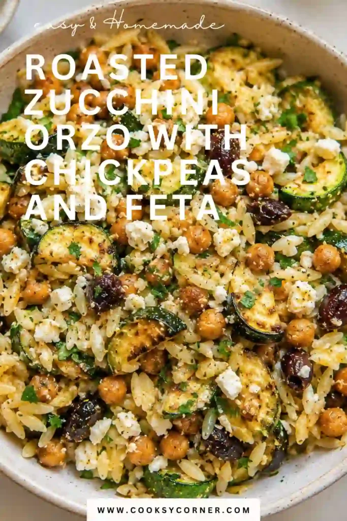 Mediterranean Roasted Zucchini Orzo featuring tender pasta, caramelized zucchini, smoked chickpeas, olives, and crumbled feta. The dish is garnished with chopped parsley and fresh lemon.