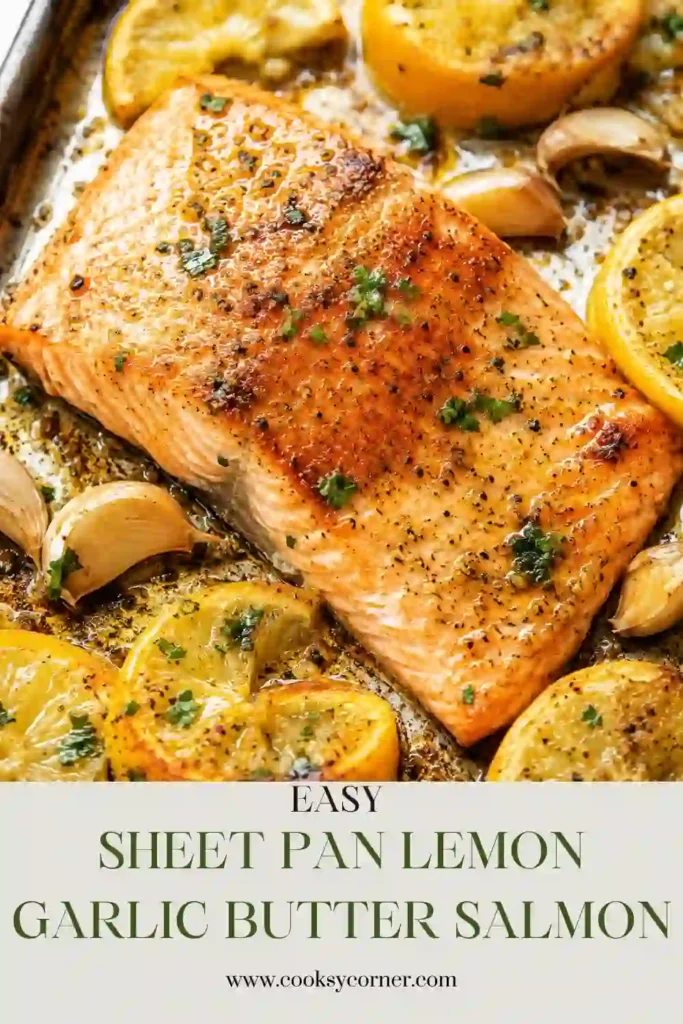 Freshly baked Sheet Pan Lemon Garlic Butter Salmon topped with chopped parsley and surrounded by fresh lemon slices. The salmon is flaky, juicy, and coated in a rich garlic butter glaze.