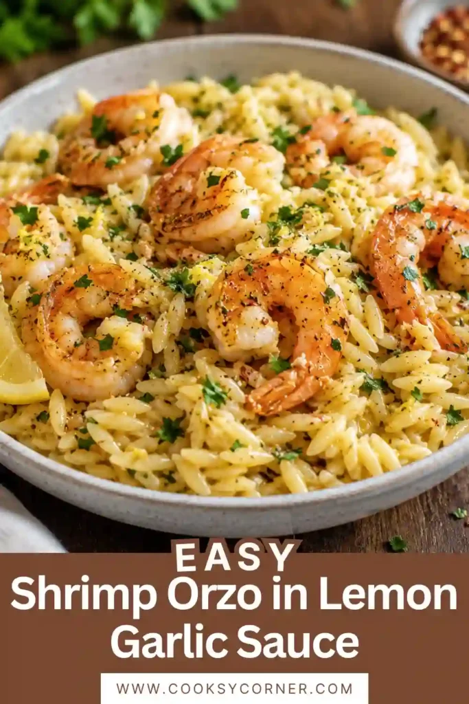 A skillet filled with Shrimp Orzo in Lemon Garlic Sauce garnished with chopped parsley and fresh lemon slices. This quick seafood recipe is colorful and inviting.