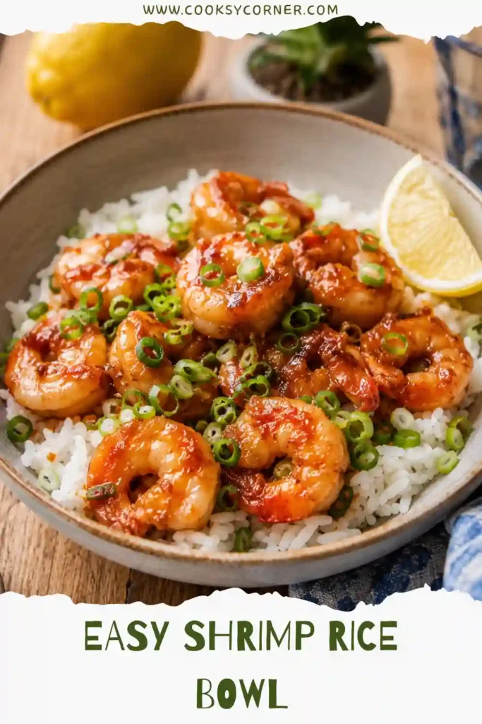 Healthy Shrimp Rice Bowl featuring tender shrimp glazed in garlic butter soy sauce served on fluffy rice and garnished with fresh scallions and lemon.