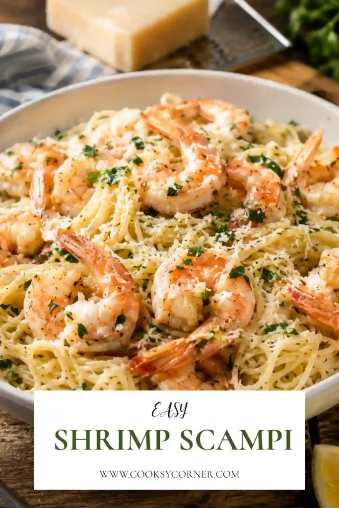Homemade shrimp scampi featuring juicy shrimp tossed with angel hair pasta in a garlic lemon butter sauce and topped with fresh herbs.