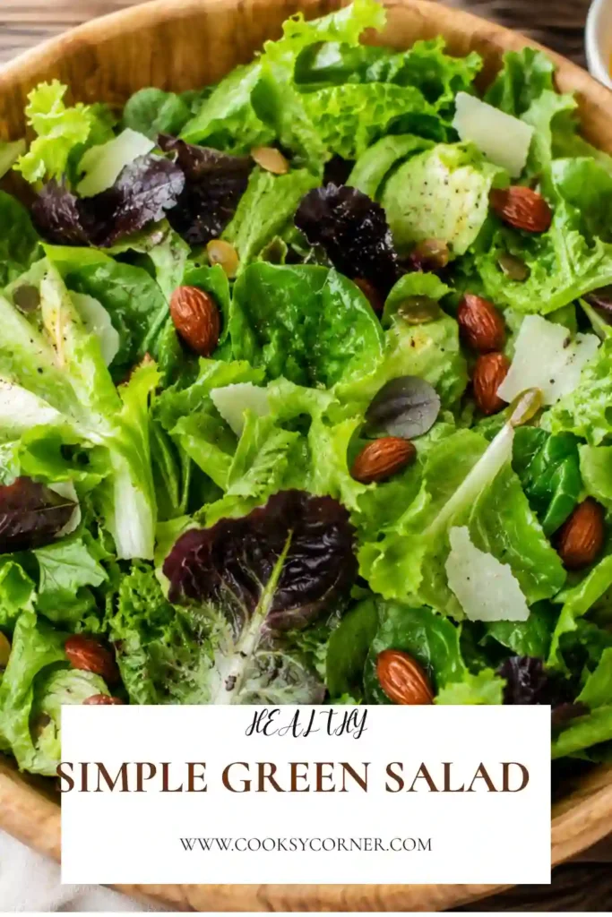 A bowl of Simple Green Salad made with butter lettuce, avocado, cucumber, Parmesan cheese, roasted tamari almonds, and lemon vinaigrette. The salad looks fresh, colorful, and perfect as a healthy side dish.