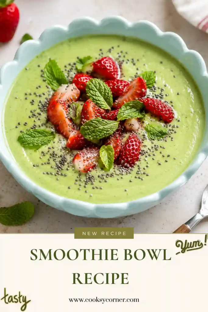 A vibrant smoothie bowl topped with strawberries, chia seeds, and fresh mint. This healthy smoothie bowl features mango, banana, avocado, and spinach for a nutritious breakfast.
