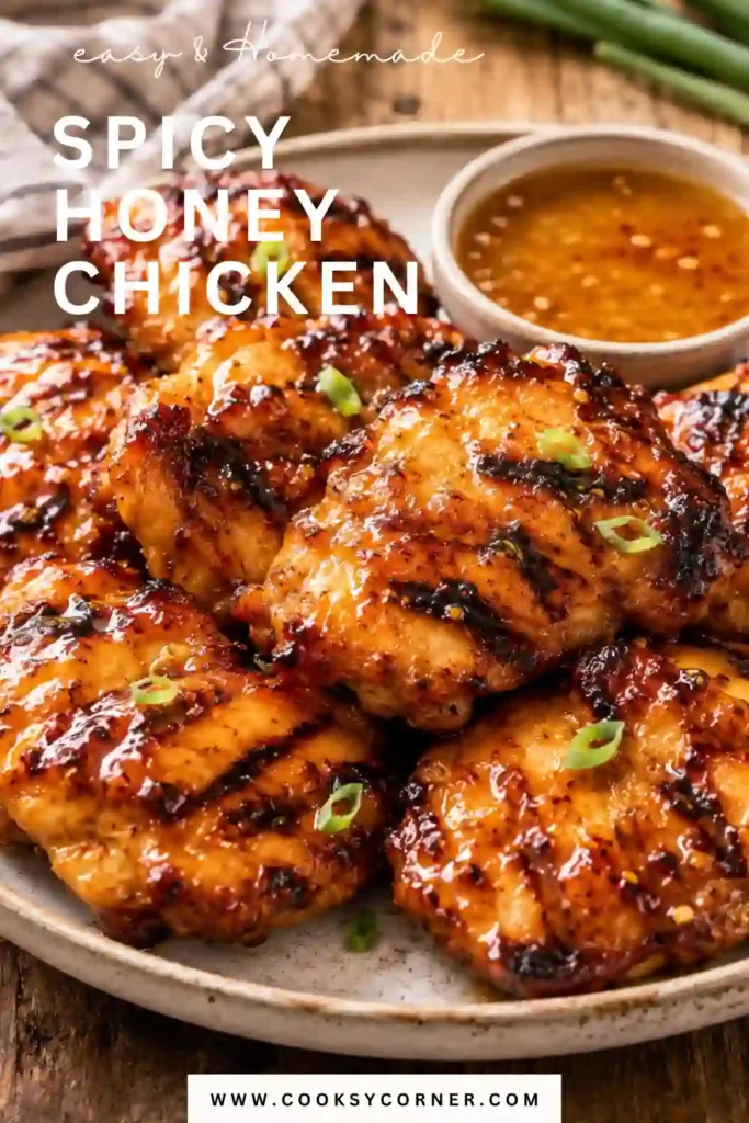 Homemade Spicy Honey Chicken served on a platter with charred grilled chicken coated in a sticky honey glaze. This easy grilled chicken recipe is sweet, spicy, and full of flavor.