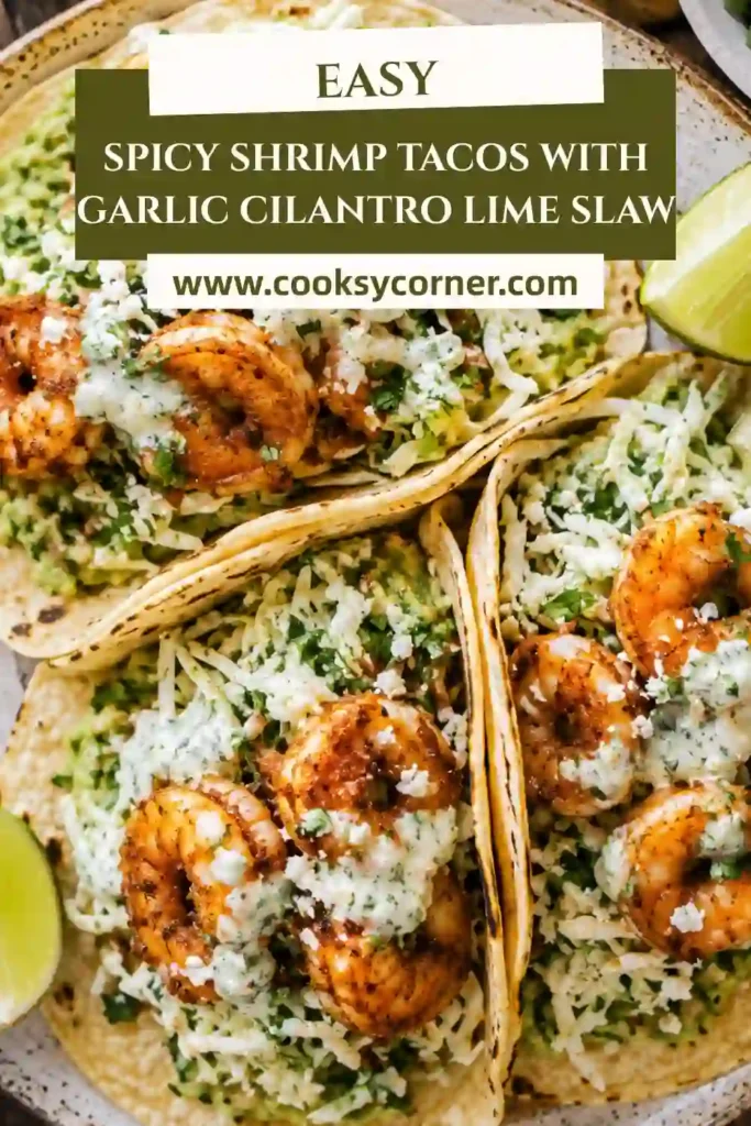 Fresh shrimp tacos topped with garlic cilantro lime slaw, Cotija cheese, and lime wedges on a rustic serving platter.