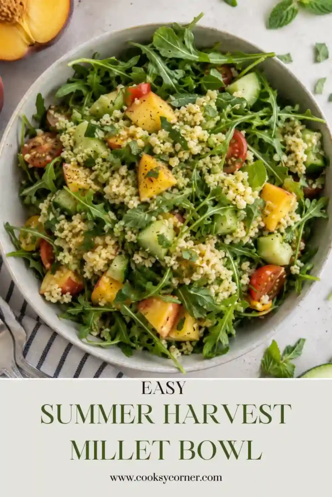 Fresh vegetarian grain bowl featuring cooked millet, peaches, avocado, tomatoes, cucumber, corn, leafy greens, and pumpkin seeds with a light dressing. Perfect for healthy meal prep.