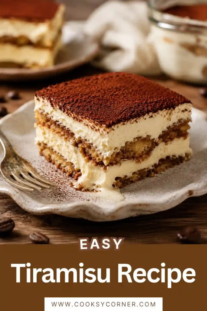 Creamy Italian tiramisu dusted with cocoa powder and served with a dessert spoon on a white plate.
