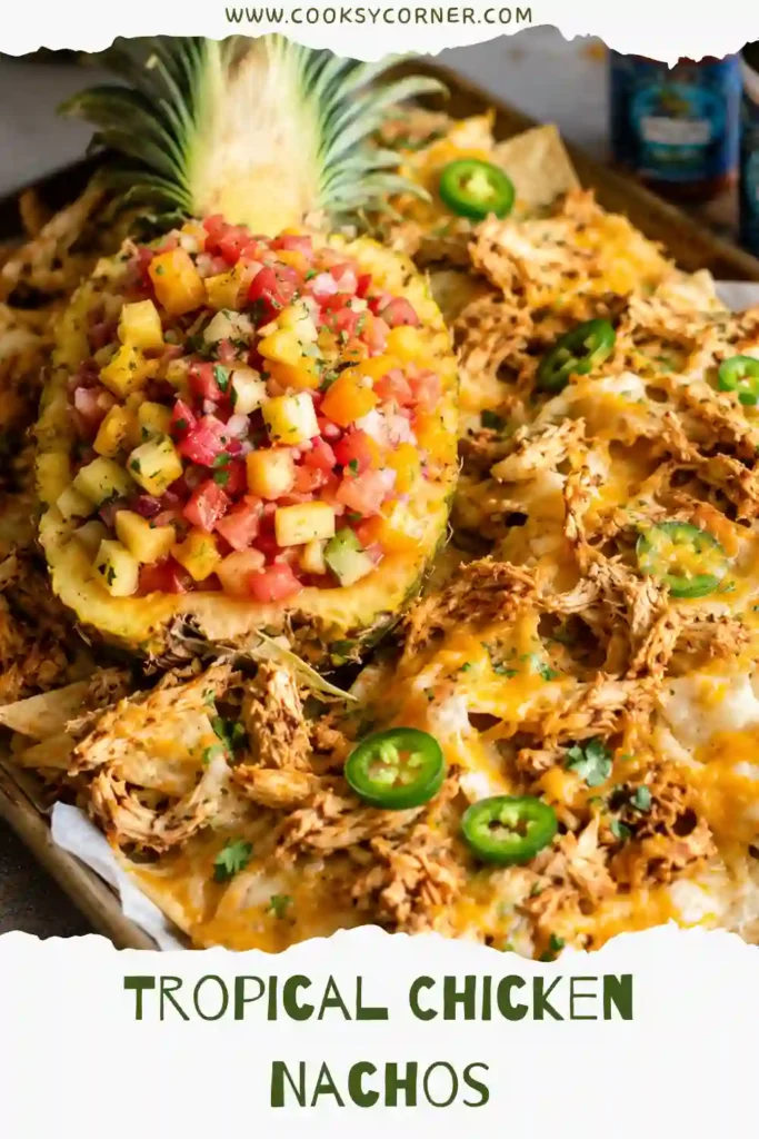 Close-up of crispy Tropical Chicken Nachos featuring juicy grilled chicken, gooey cheese, pineapple salsa, and fresh herbs. A perfect summer appetizer.