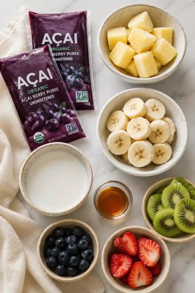 A vibrant vegan Tropical Acai Bowl garnished with blueberries, kiwi, and strawberries. This refreshing smoothie bowl is thick, creamy, and ideal for a healthy breakfast or brunch.
