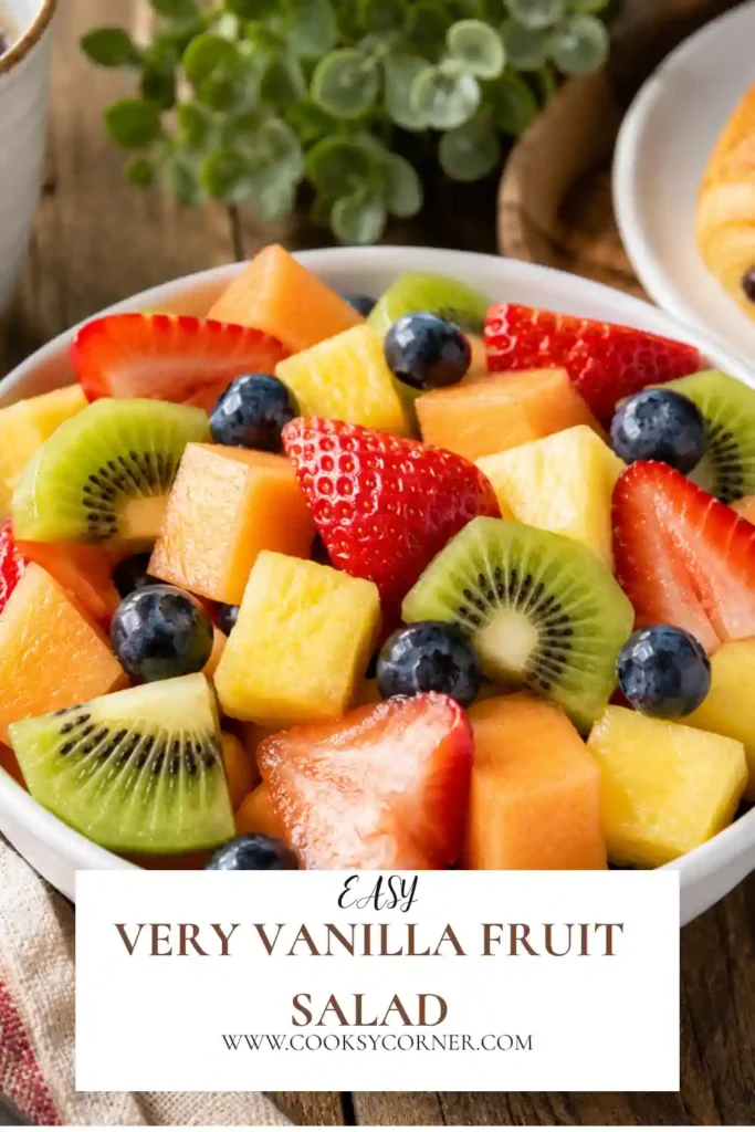 Fresh summer fruit salad featuring juicy berries, pineapple chunks, cantaloupe, and kiwi. The colorful fruit is lightly tossed with vanilla extract for a naturally sweet finish.